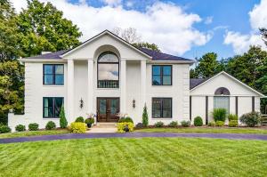 a large white house with a lawn at Luxury Maineville Villa with Private Pool and Deck in Maineville