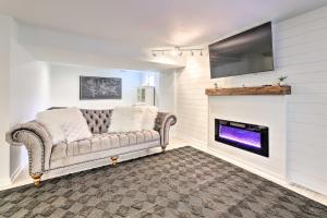 a living room with a couch and a fireplace at Luxury Maineville Villa with Private Pool and Deck in Maineville