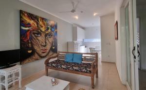 a living room with a painting of a woman on the wall at Starling villas in Sanur