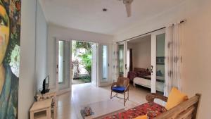 a living room with a couch and a tv in it at Starling villas in Sanur