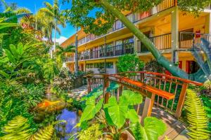 an apartment building with a walkway in a garden at Prince Kuhio 323 in Koloa