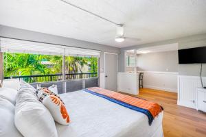 a bedroom with a large bed and a large window at Prince Kuhio 323 in Koloa