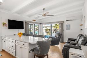 a living room with a table and chairs at Relaxation Station in Key Colony Beach