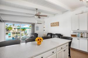 a kitchen with a table with chairs and a ceiling fan at Relaxation Station in Key Colony Beach