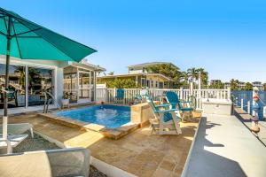 a backyard with a swimming pool and a house at Relaxation Station in Key Colony Beach