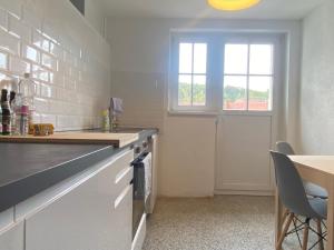 a kitchen with a counter and a table and a window at Apt5 - Ferienwohnung Brötzingen im 4 OG in Pforzheim +16 photos