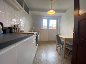 a kitchen with a counter and a table and a window at Apt5 - Ferienwohnung Brötzingen im 4 OG in Pforzheim