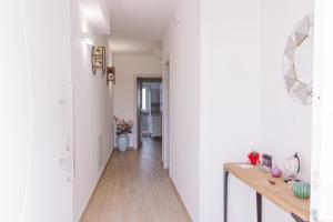 a hallway of a home with white walls and wooden floors at B&B Da Bea in Chieti