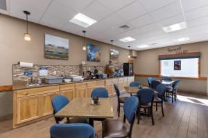 a restaurant with tables and chairs and a counter at Best Western Pioneer in Lusk