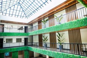 an interior view of a building with green plants at SureStay Studio by Best Western Clarkview Angeles City in Angeles