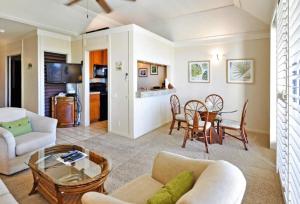 a living room with a couch and a table at Kiahuna Plantation Unit 118 - 2nd Floor Expansive Views, Air Conditioning in Koloa