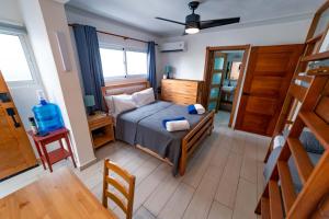 a small bedroom with a bed and a table at Todo Bien Quality Studio Beachfront Kite Beach in Cabarete
