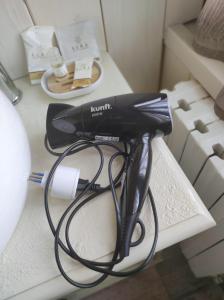 a black hair dryer sitting on a table at Camere Infinity Rooms in Castelfidardo