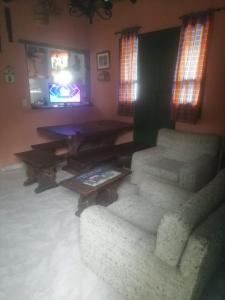a living room with a couch and a table at Hotel Boutique La Cueva de la Luna, El Arte se hace Descanso in Duitama
