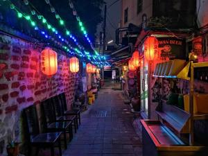 an alley with red and blue lights on a building at Tainan Homestay in Tainan