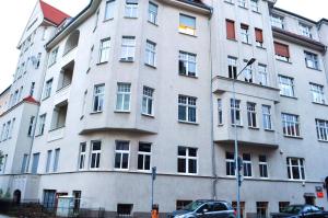 a large white building with a lot of windows at Happy House Hostel in Poznań