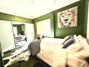 a bedroom with a bed with a painting of a tiger at Entire Blaxland Cottage in Blaxland