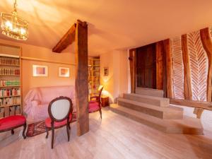 a living room with stairs and a table and chairs at Gîte Bellegarde, 4 pièces, 6 personnes - FR-1-590-2 in Bellegarde-du-Loiret