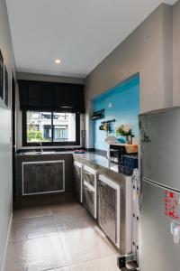 a kitchen with a stainless steel refrigerator and a window at PP Pool Villa Huahin in Hua Hin
