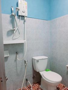 uma casa de banho com um WC branco e um chuveiro em Sala Bua Room em Praia de Karon