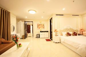 a large bedroom with a bed and a living room at Tuyet Son Hotel (TS Ocean Hotel) in Danang