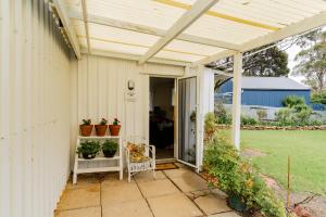 a white pergola on the side of a house at Stay in Blackwood in Blackwood
