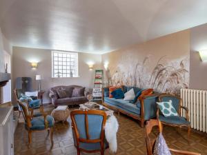 a living room with a blue couch and chairs at Maison d'époque avec sauna, jacuzzi et salle de jeux à 1h de Paris - Idéale familles/amateurs de stages - FR-1-590-4 in Boisseaux