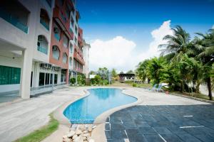 a swimming pool in front of a building at Marina Island Pangkor Resort & Hotel in Lumut