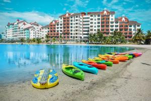 a row of kayaks lined up on the beach near a resort at Marina Island Pangkor Resort & Hotel in Lumut