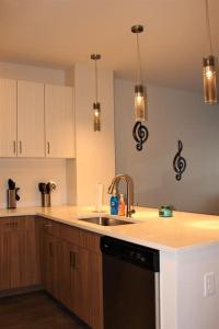 a kitchen with a sink and a dishwasher at Luxury in the Gulch in Nashville