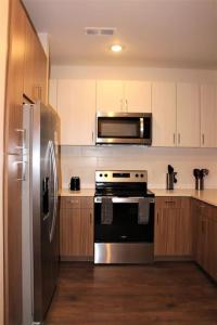 a kitchen with a stainless steel refrigerator and a stove at Luxury in the Gulch in Nashville