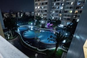 a view of a swimming pool at night from a building at Times City Homestay in Hanoi
