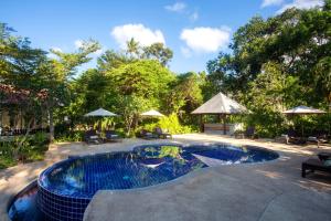 a swimming pool in a yard with trees at Panalee Koh Samui Resort - SHA Plus in Ban Bang Po
