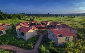 an aerial view of a group of houses in a field at Aranyak Resort Kanha in Dhanwār