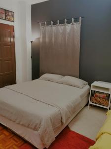 1 dormitorio con 1 cama blanca y ventana en D2Pie Homestay en Subang Jaya