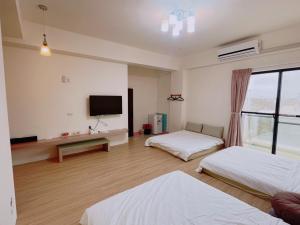 Uma cama ou camas num quarto em 澎湖樂在綺中民宿 第580號