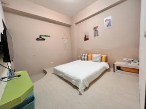 Uma cama ou camas num quarto em 澎湖樂在綺中民宿 第580號