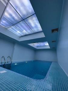 a room with a swimming pool with a skylight at Golden Samarkand Hotel in Samarkand
