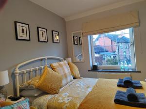 a bedroom with a bed with towels on it at Rooms by the River at Glan Aber in Cynwyd