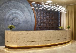 a lobby with a reception desk and a circular wall at Basqal Resort & SPA in Basqal