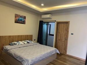 a bedroom with a bed with a picture on the wall at SKY and STARLOFT in Ban Bang Phaniang