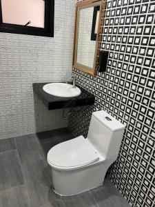 a bathroom with a toilet and a sink at SKY and STARLOFT in Ban Bang Phaniang