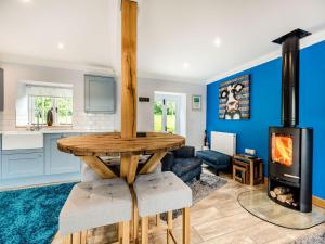 a kitchen and living room with a wood stove at The Dog And Trout in Findon