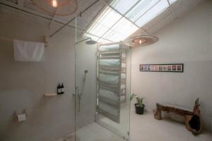 a bathroom with a shower with a glass door at Circle 