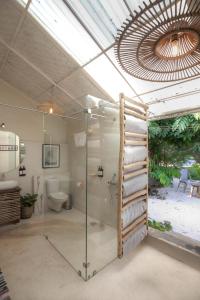 a bathroom with a glass shower and a toilet at Circle 