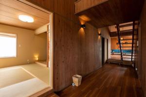 a room with wooden walls and a large window at オーシャニア一宮 in Ichinomiya