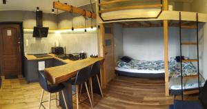 ein Zimmer mit einer Bar und einem Etagenbett in der Unterkunft AM Apartament in Wałcz