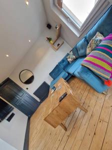 an overhead view of a living room with a blue couch at Beach front apartment in Edinburgh