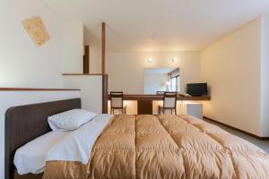 Postel nebo postele na pokoji v ubytování Shiga Kogen Olympic Hotel
