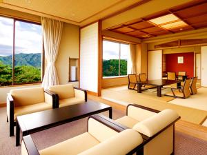 a living room with couches and a table at Jodogahama Park Hotel in Miyako